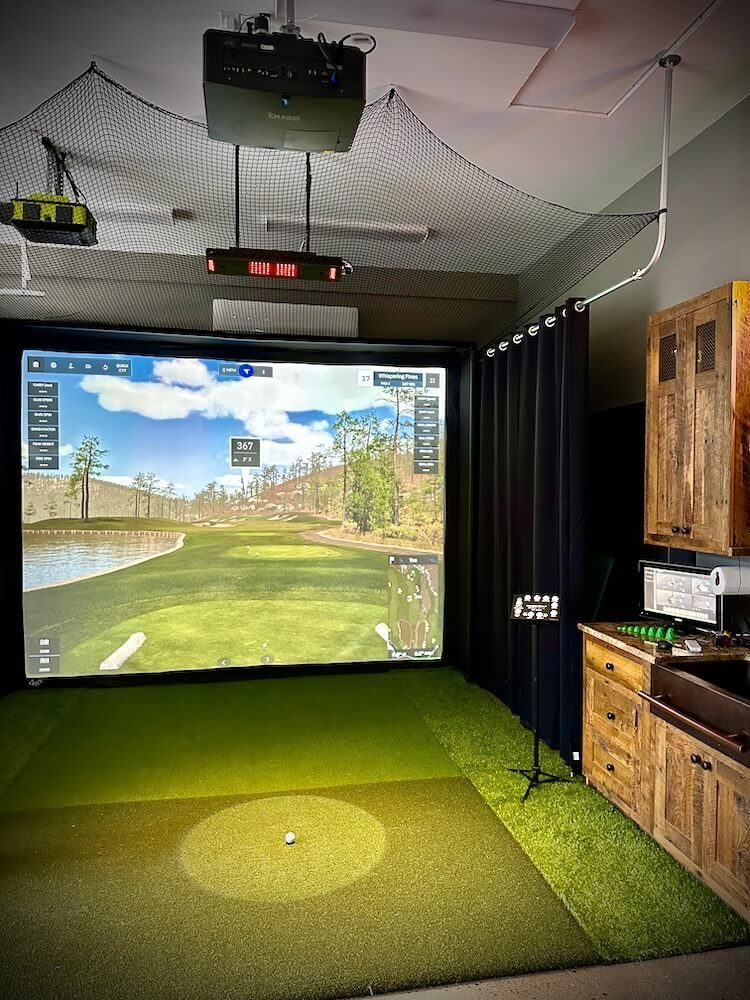 Garage golf simulator with rustic cabinetry