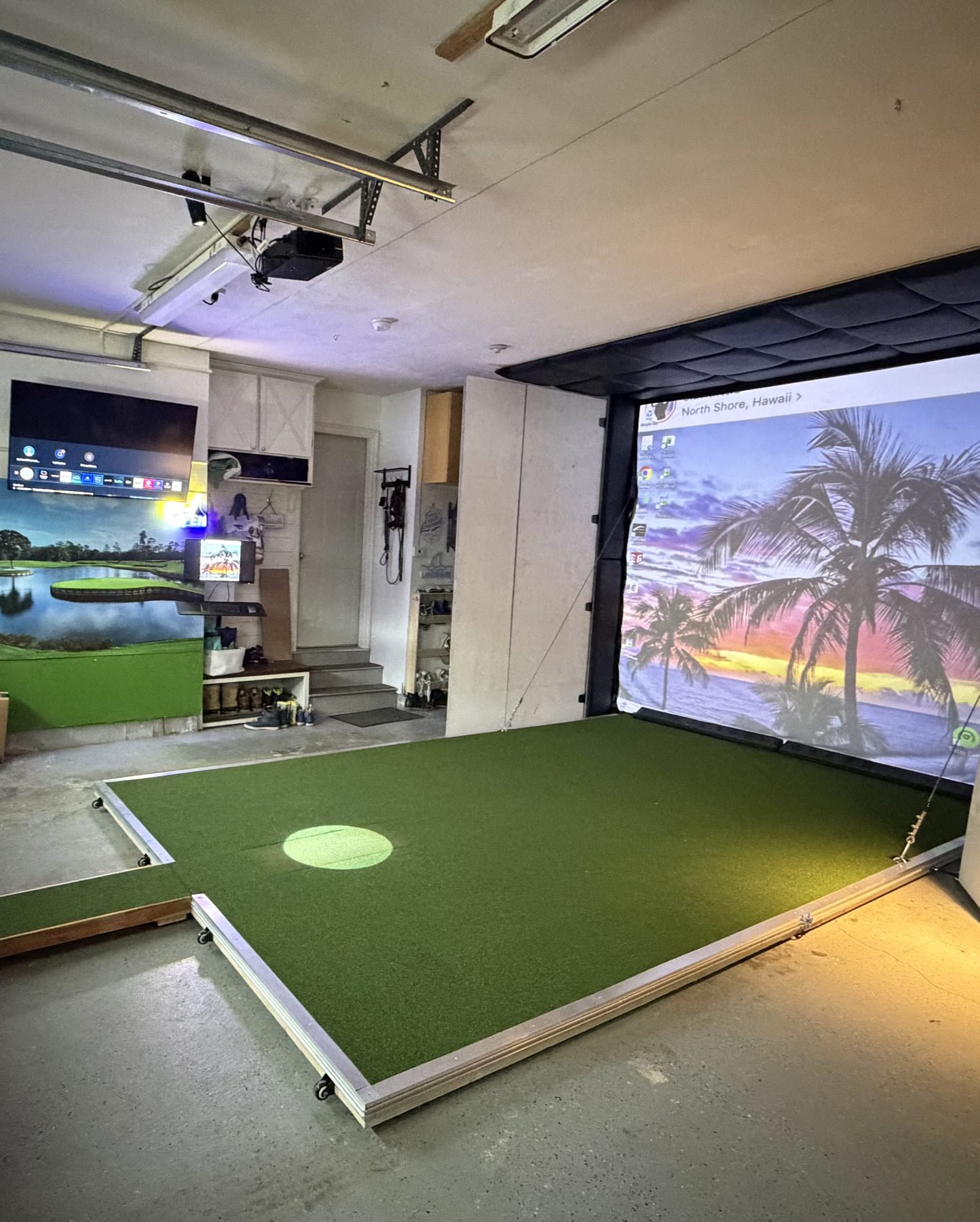 Garage golf simulator with turf hitting area